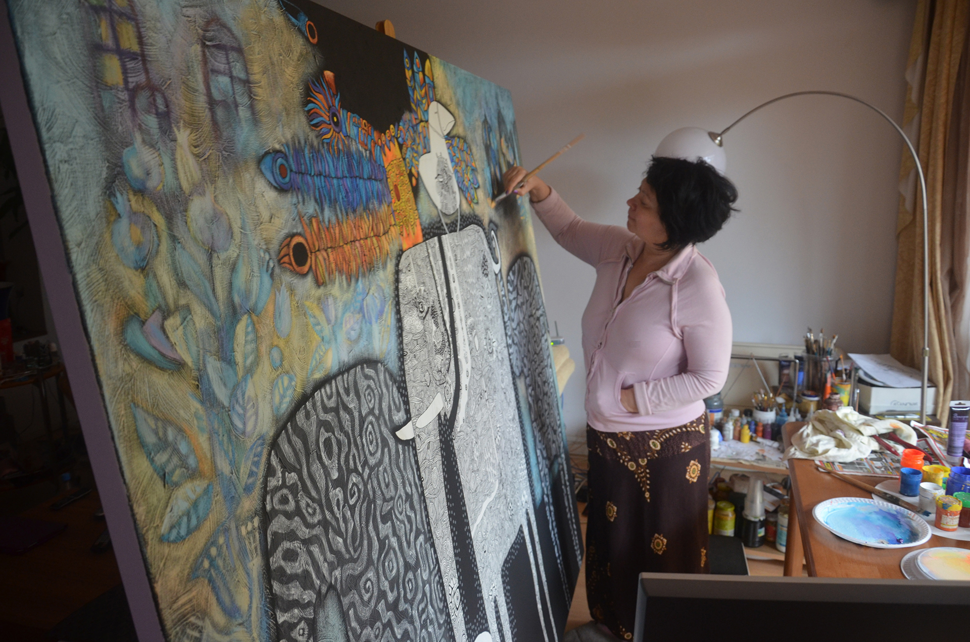 Yelena Revis painting in her studio