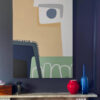 Blue Fog abstract painting by Yelena Revis framed above a fireplace mantel in a dark modern interior