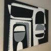 Angled side view of Contrasts II showing the black canvas edge and bold geometric shapes