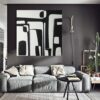Large black and white abstract painting named Contrasts by Yelena Revis hanging on a dark wall above a gray sofa in a modern living room.