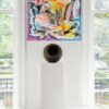 Fresh Abundance Gallery View — Painting by Yelena Revis Fresh Abundance painting by Yelena Revis displayed in a bright gallery interior above a sculpture pedestal.