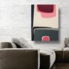 Pink Reflection abstract painting by Yelena Revis on a white brick wall above a leather sectional sofa