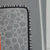 Yelena Revis signature beside a grey pebble-texture block with stitched border in Premonition of Dawn