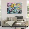 Splash of Blossom Living Room View — Painting by Yelena Revis Splash of Blossom painting by Yelena Revis styled above a neutral sofa in a bright, modern living room interior.