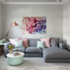The Colourful Rhythm Abstract Art Interior Mockup – Contemporary Living Room Decor by Yelena Revis The Colourful Rhythm low-poly abstract painting by Yelena Revis above a grey sofa with pink and mint cushions