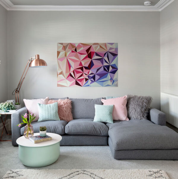 The Colourful Rhythm Abstract Art Interior Mockup – Contemporary Living Room Decor by Yelena Revis The Colourful Rhythm low-poly abstract painting by Yelena Revis above a grey sofa with pink and mint cushions